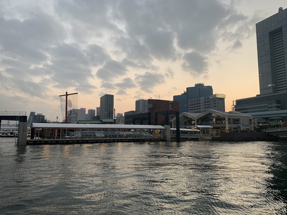 a river with a train on it and a city in the background