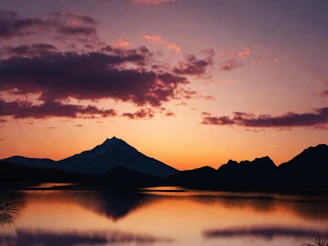 An intricate adult puzzle showing a serene mountain landscape at sunset.