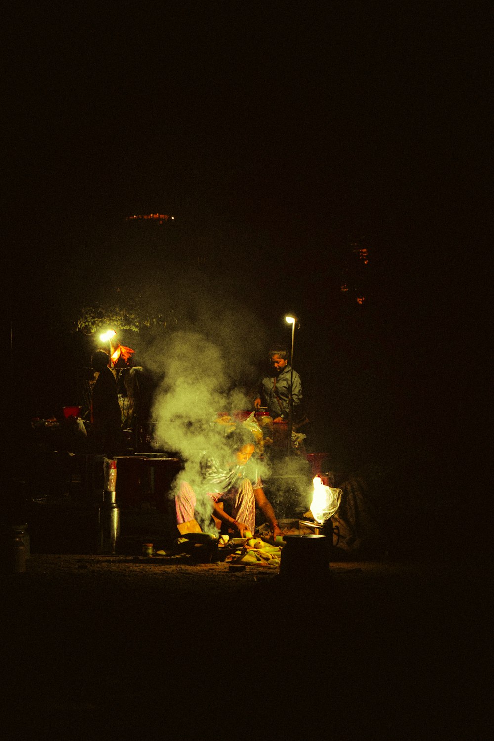 a group of people sitting around a fire pit