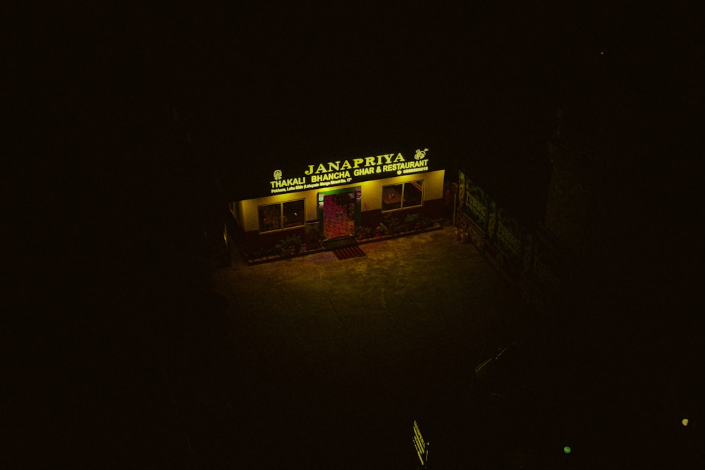 a building lit up at night with a neon sign