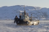 Pilots confidently steering a ribx boat through cold, rugged waters emphasizing safety and stability.