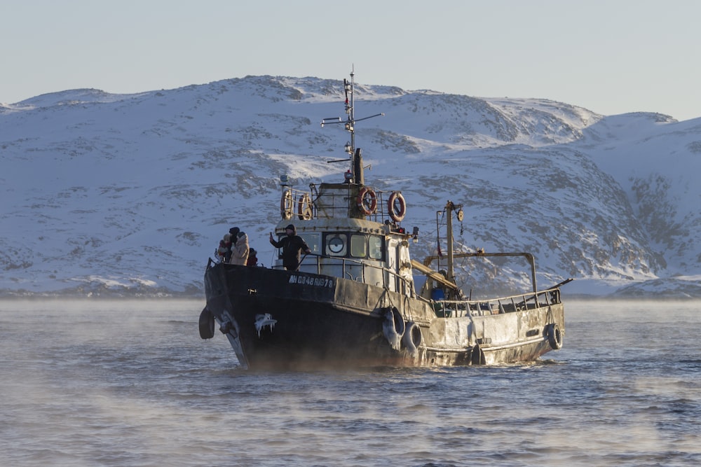 a boat in the water with a mountain in the background