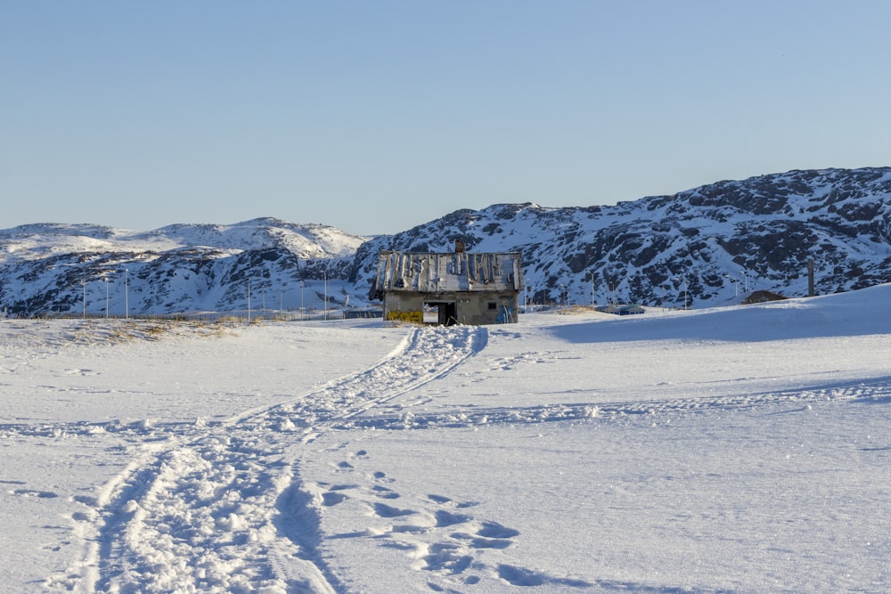 a snow covered field with tracks in the snow