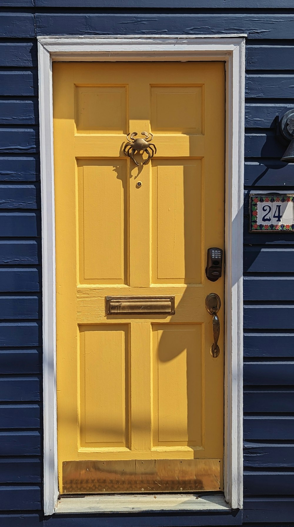 a yellow door on a blue building
