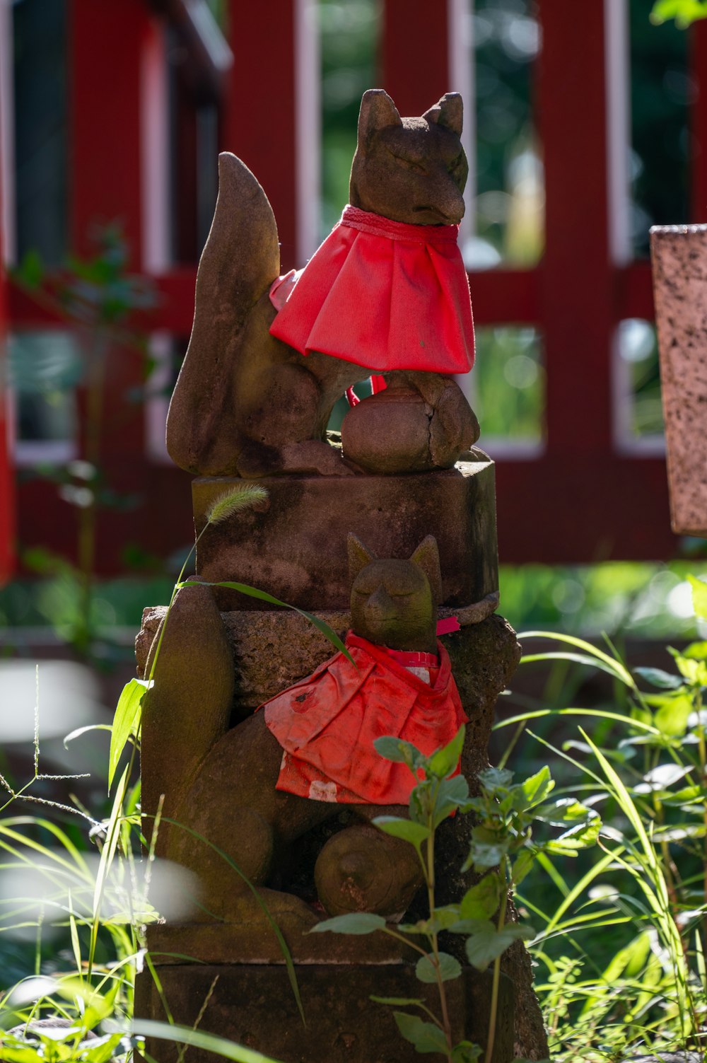 a statue of a cat wearing a red dress