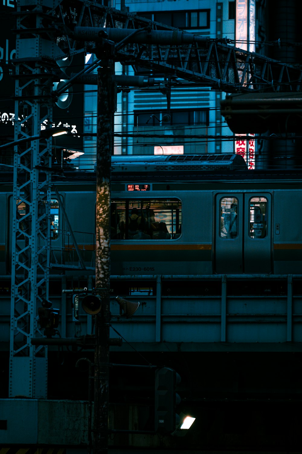 a train traveling down train tracks next to a tall building