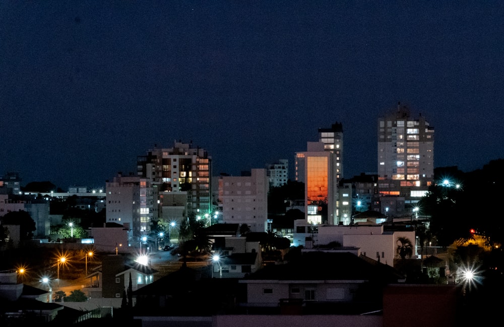 a view of a city at night with buildings lit up