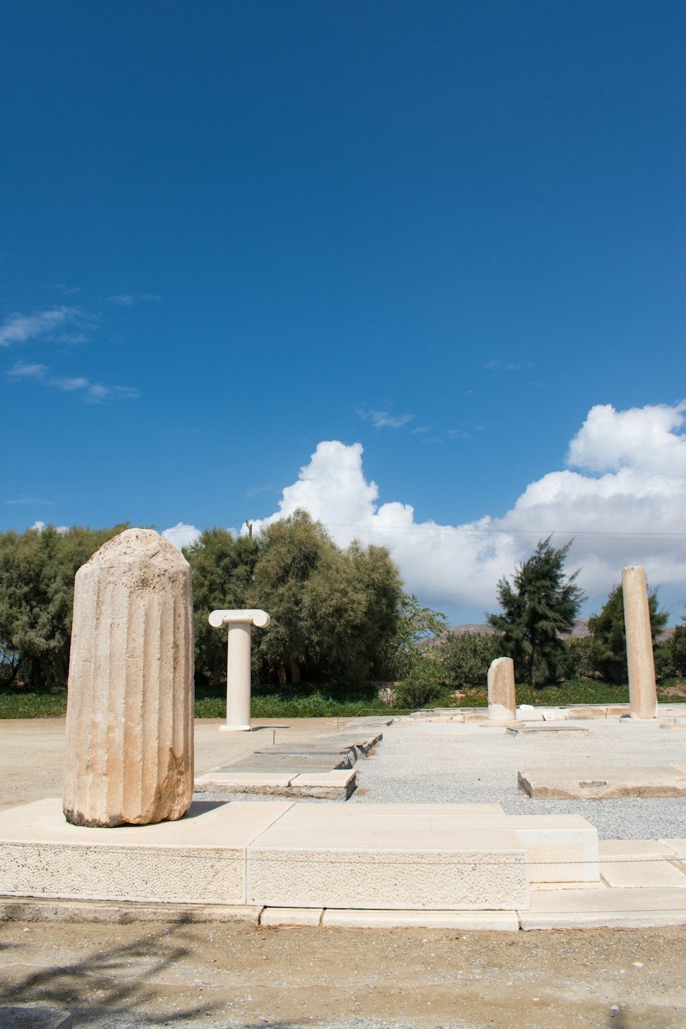 a large stone pillar sitting in the middle of a park