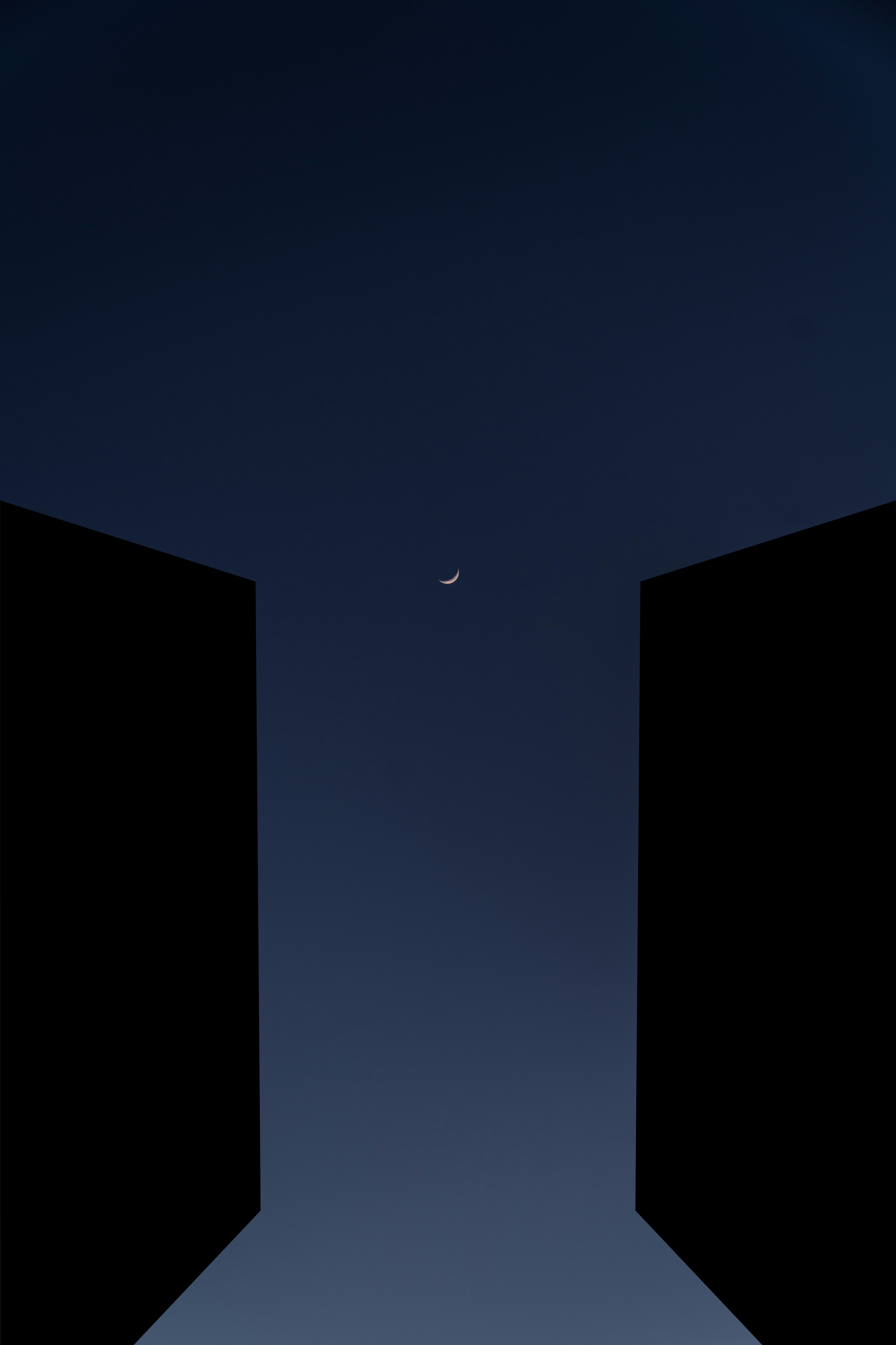 two open doors with a half moon in the sky