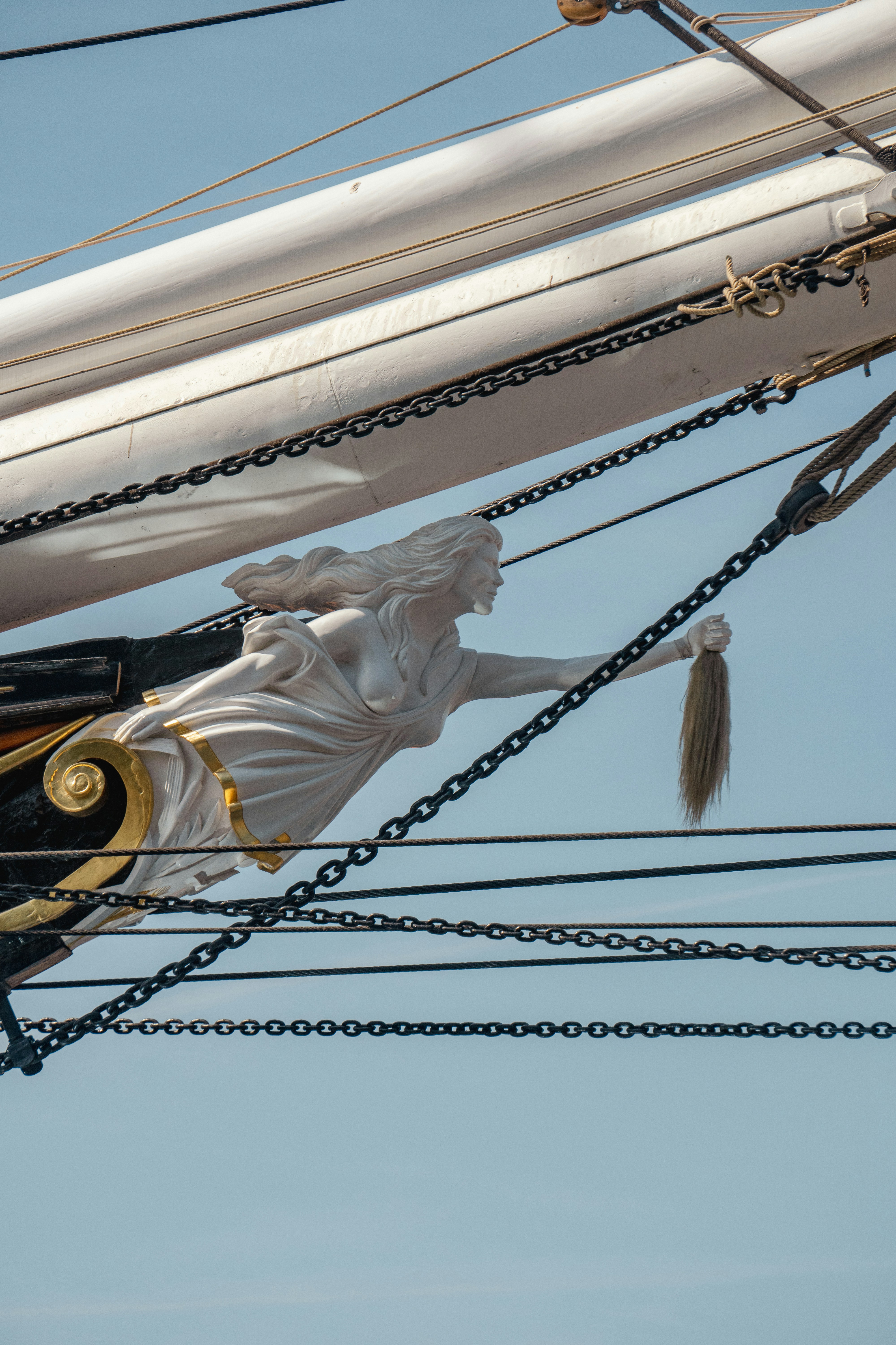 a statue of a woman on top of a ship