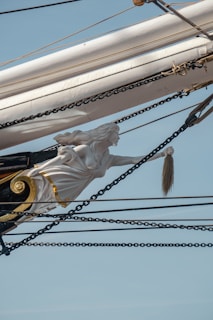 A close-up of a ship's figurehead carved with mythical creatures.