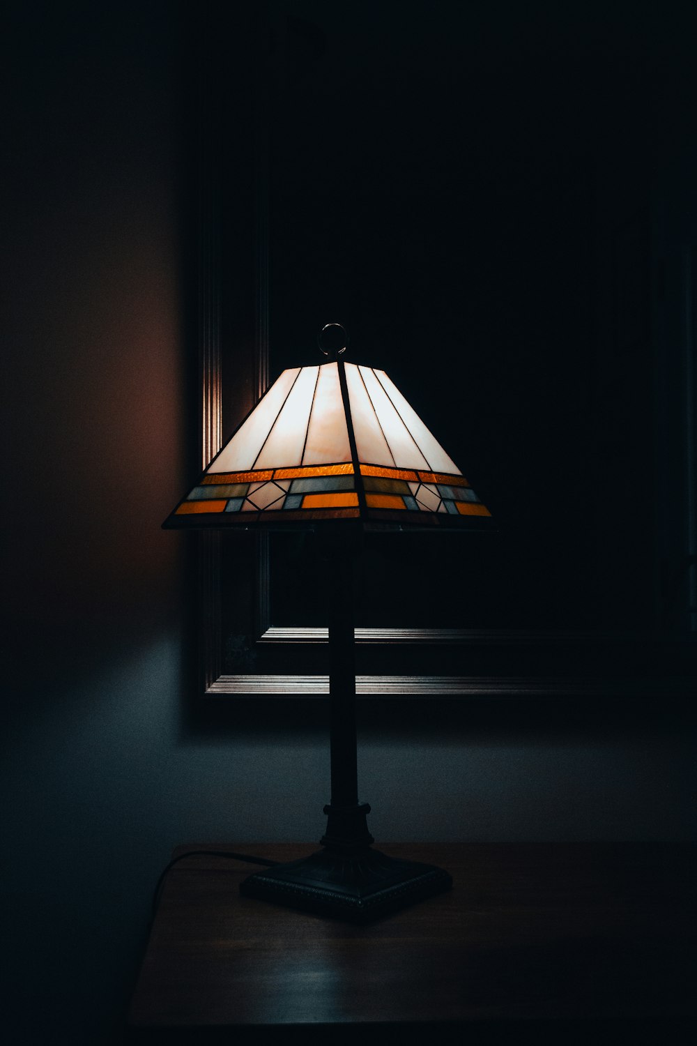 a lamp sitting on top of a wooden table