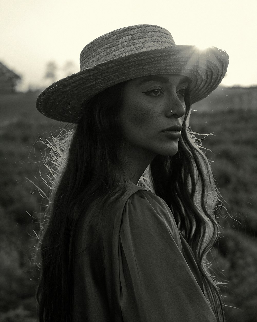 a woman with long hair wearing a hat