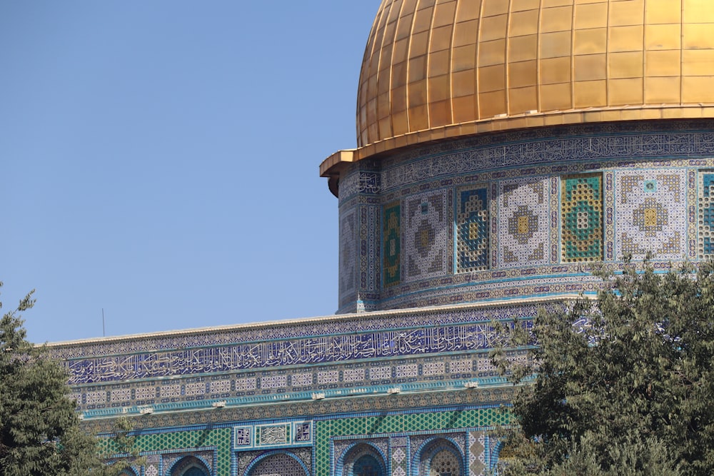 a dome on top of a building with blue and gold tiles