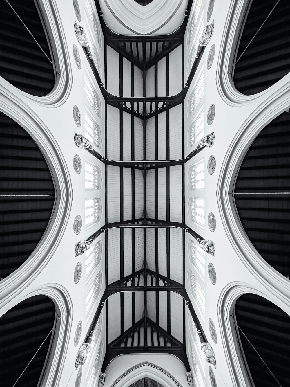 a black and white photo of the ceiling of a building
