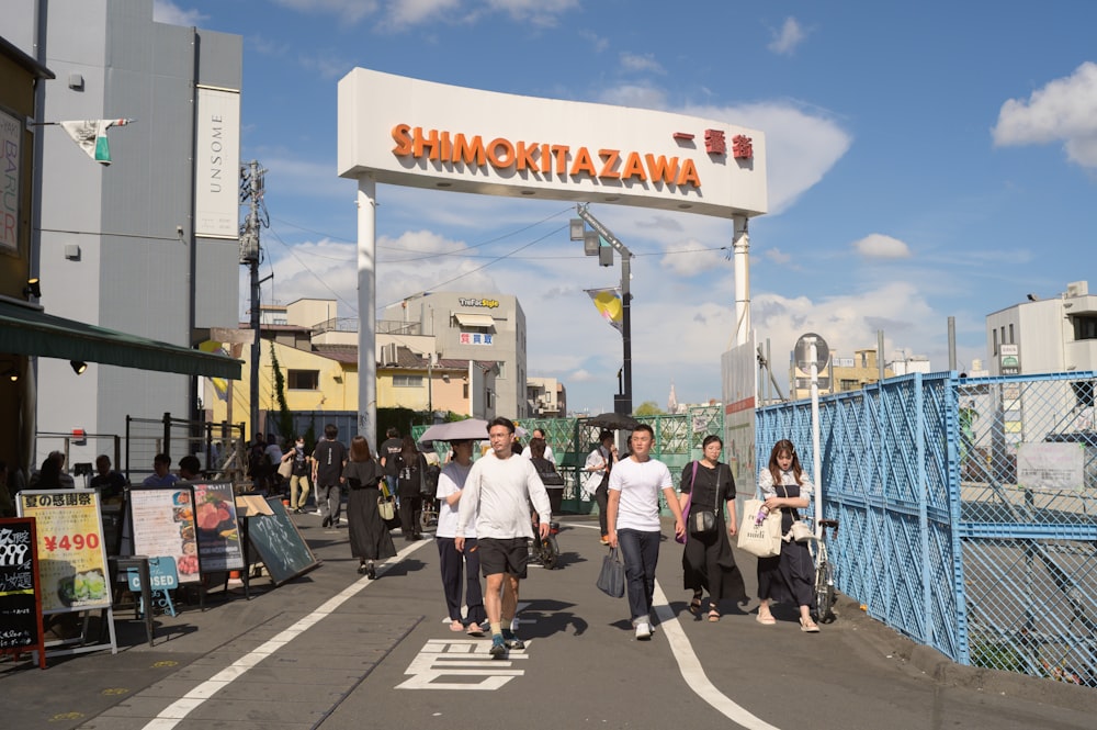 a group of people walking across a bridge