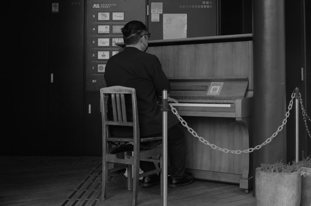 a person sitting at a piano in a room