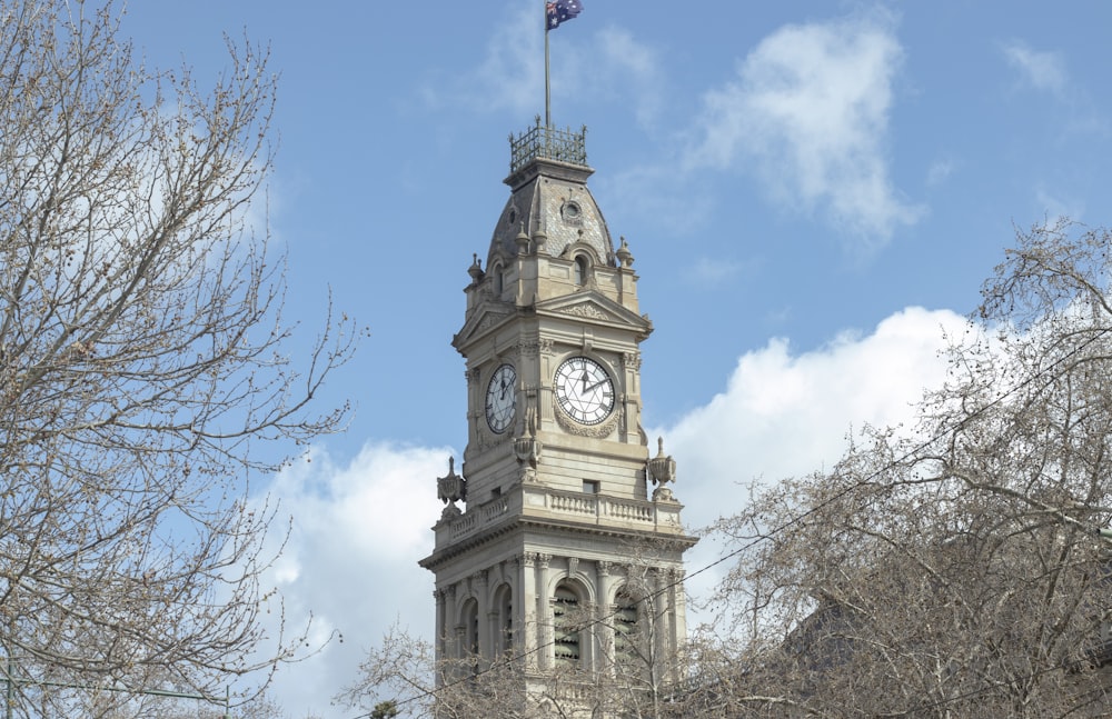 a clock tower with a flag on top of it