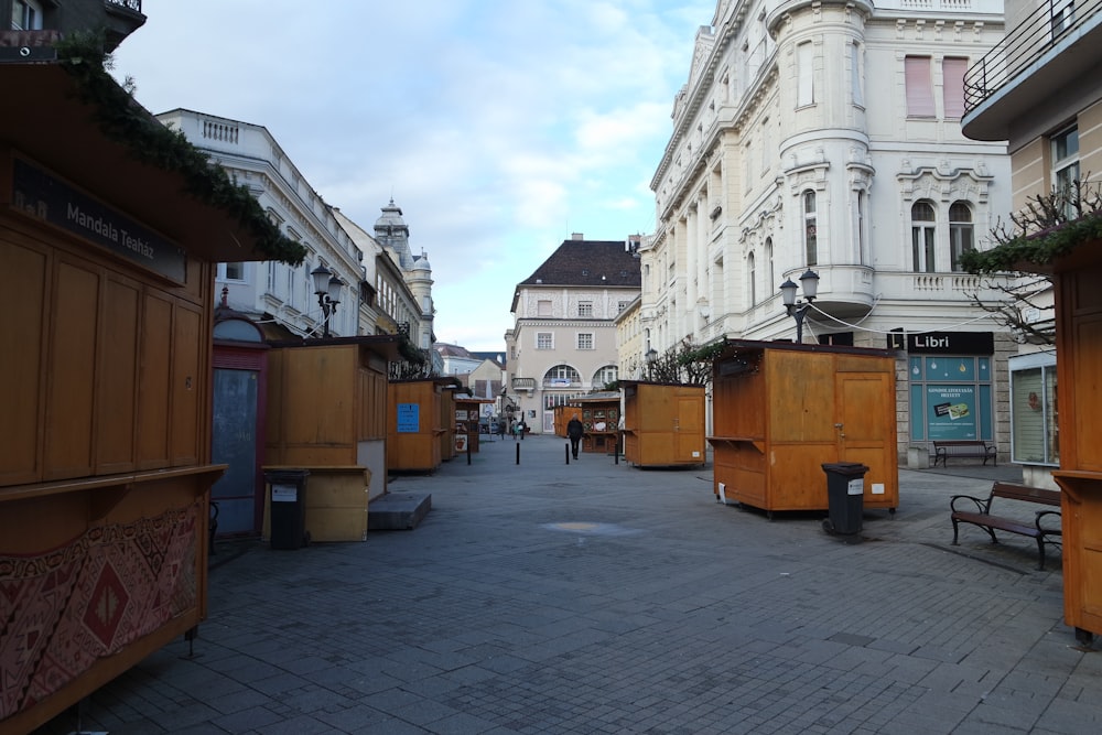 a city street lined with buildings and benches