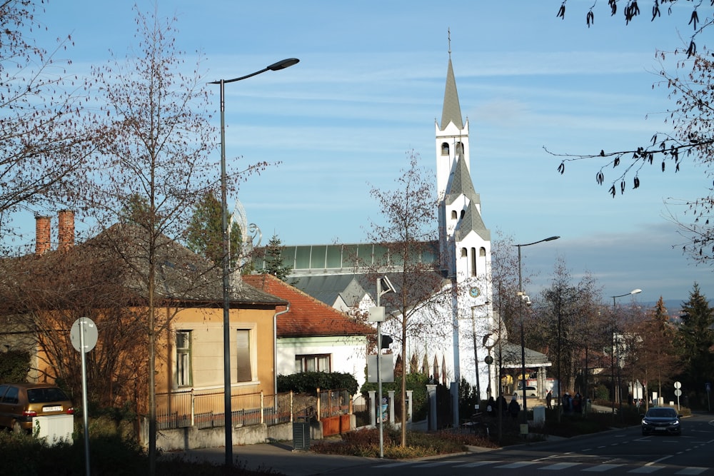 a church with a steeple on a street corner