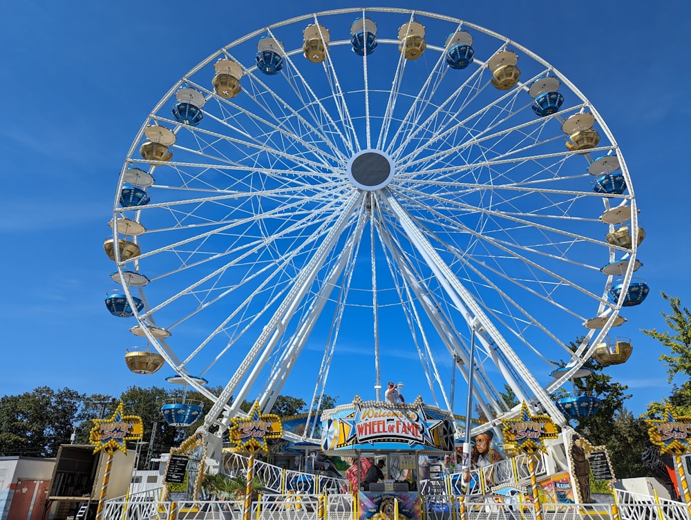 a large ferris wheel sitting next to a carnival ride