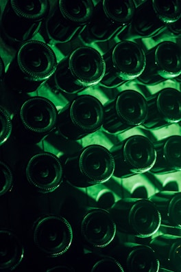 An artistic shot of sipstart bottles lined up against a bright urban mural background.