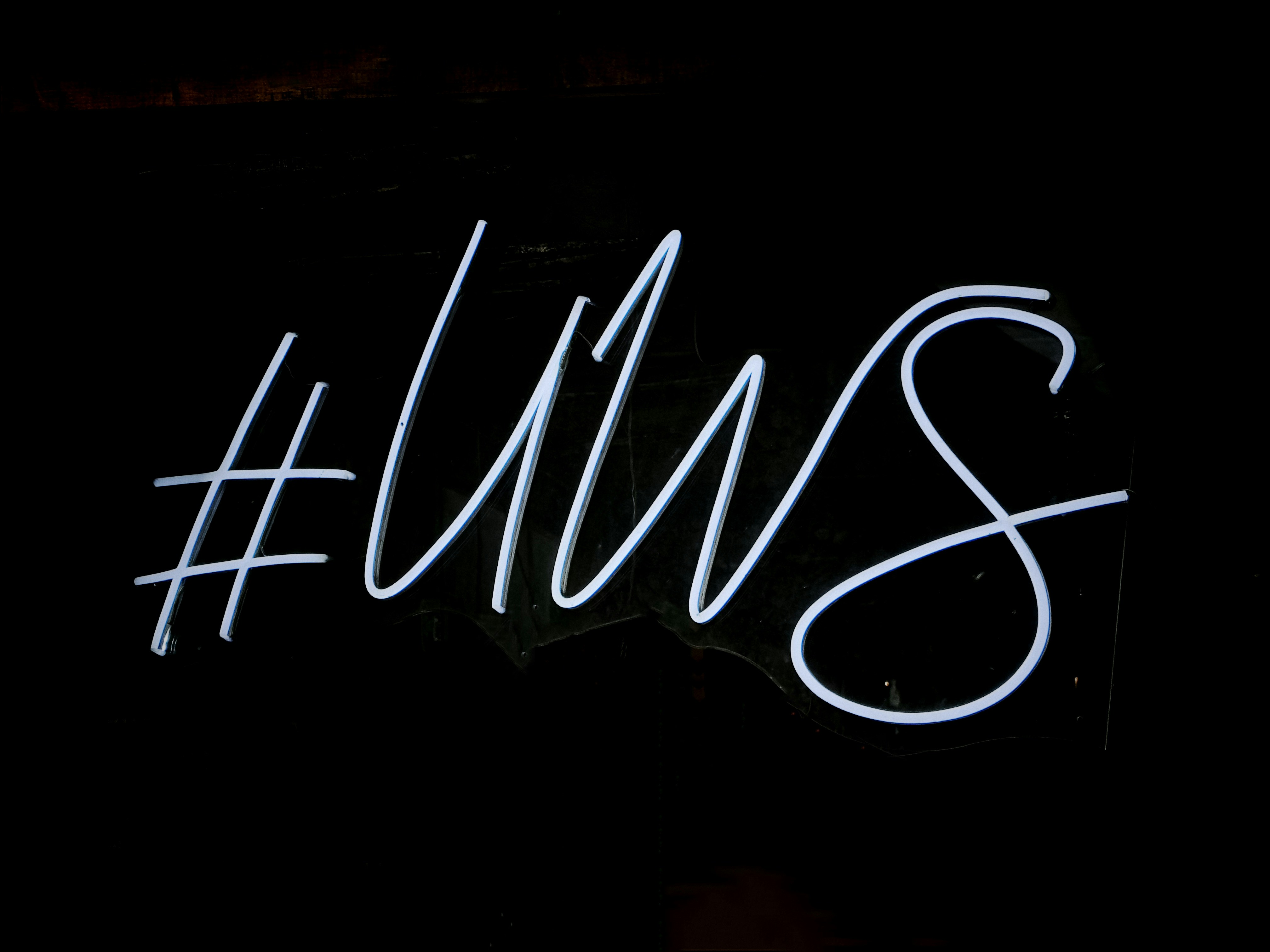 a close up of a neon sign on a building