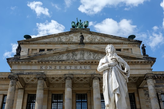 a statue of a man standing in front of a building