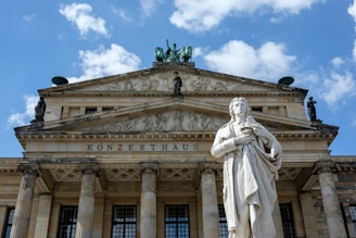 a statue of a man standing in front of a building
