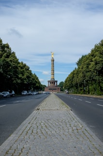 a view of a street with a monument in the background