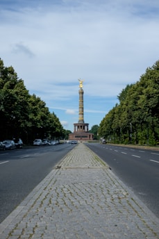 a view of a street with a monument in the background