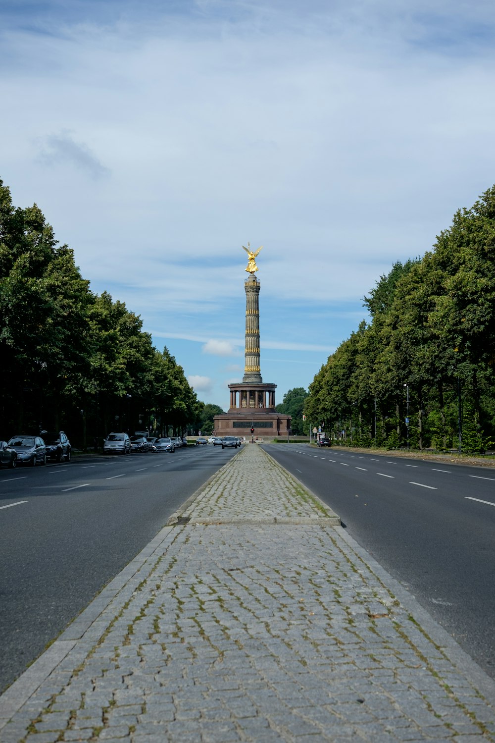 a view of a street with a monument in the background