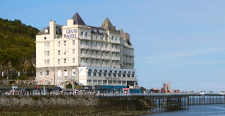 a large white building sitting on the side of a body of water