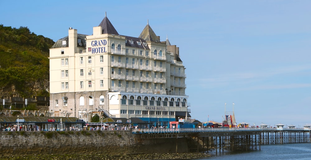 a large white building sitting on the side of a body of water