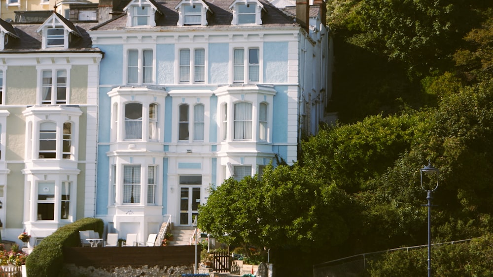 a large blue and white building with trees in front of it