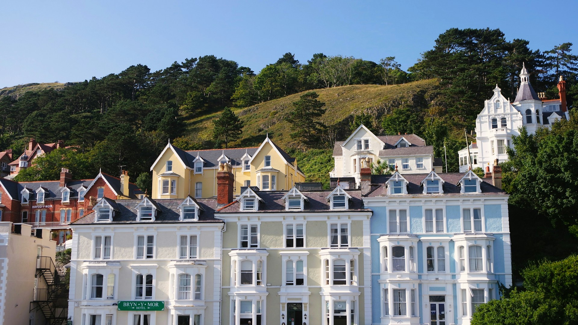 a row of multi - colored houses on a hillside
