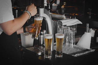 Technician carefully installing a long draw beer system in a cozy bar setting.