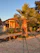 A cozy villa terrace at sunset with soft golden light and lush greenery around.