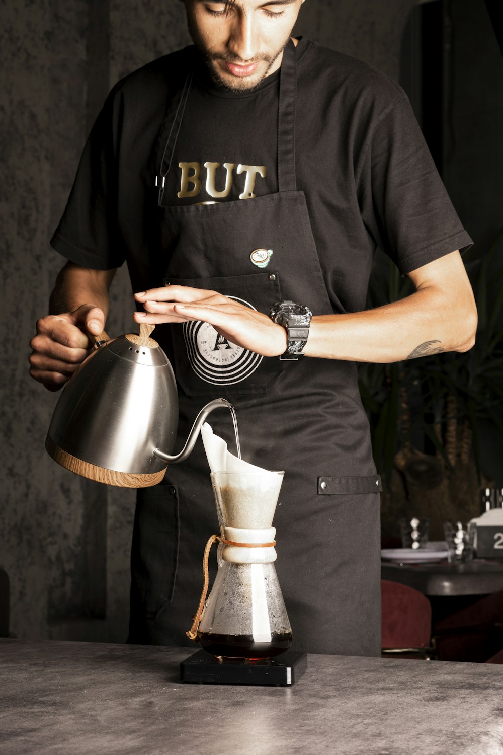 a man pours coffee from a coffee pot