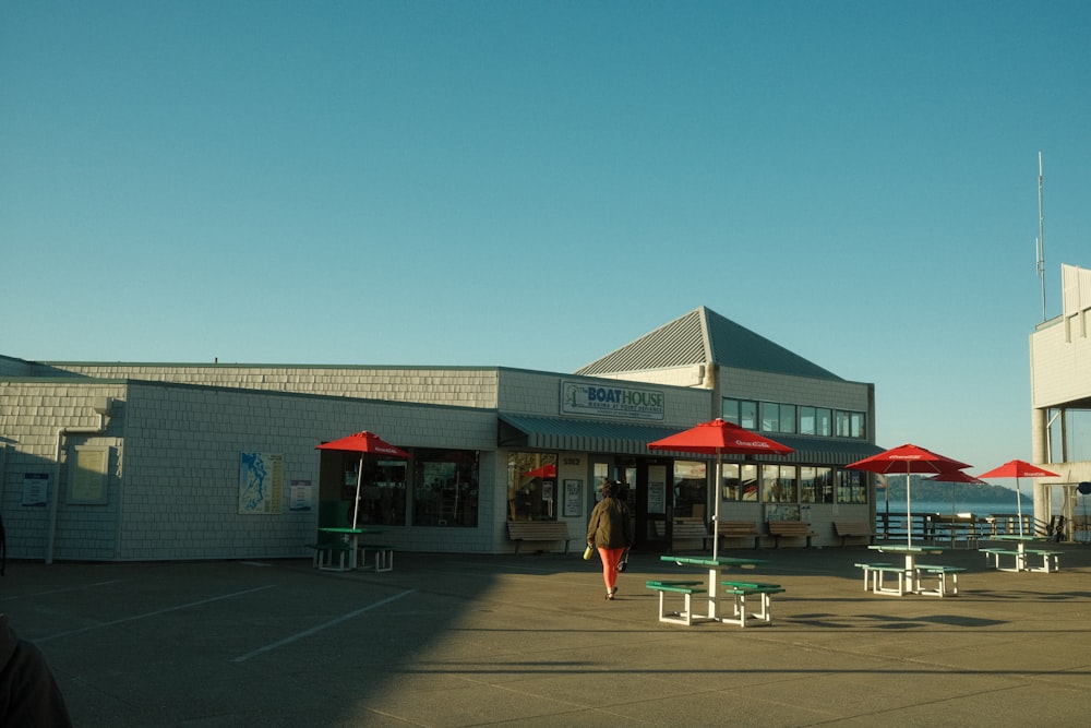 a building with tables and umbrellas in front of it