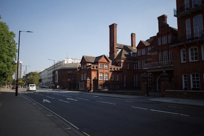A peaceful street view of tenement apartments.