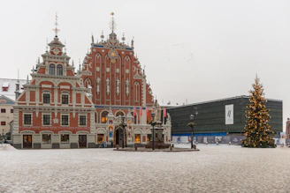 a large building with a christmas tree in front of it