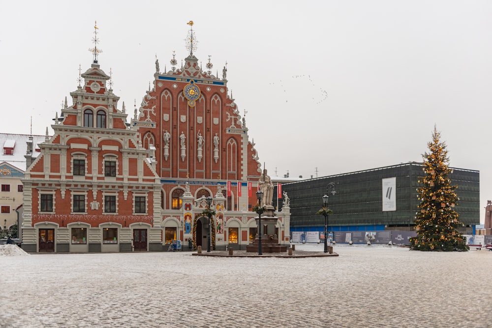 a large building with a christmas tree in front of it