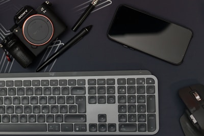 Flat lay of web design tools including a keyboard, mouse, and color swatches.