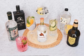 a table topped with bottles of alcohol and glasses