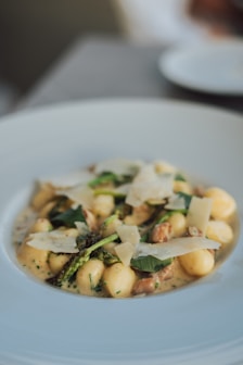a white plate topped with pasta and broccoli