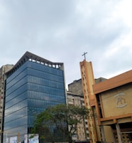a tall building with a cross on top of it