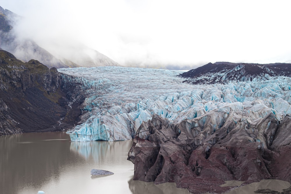 a large glacier with a mountain in the background