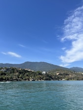 a body of water with a mountain in the background