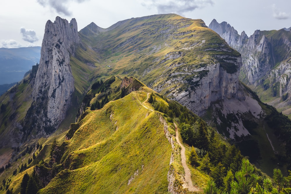 a view of a mountain range with a trail going up the side of it